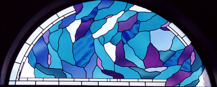 Arched leaded glass window in cobalt, turquoise and violet