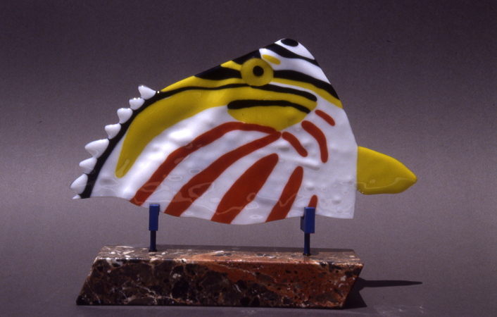 Fused glass triggerfish sculpture mounted on a marble base